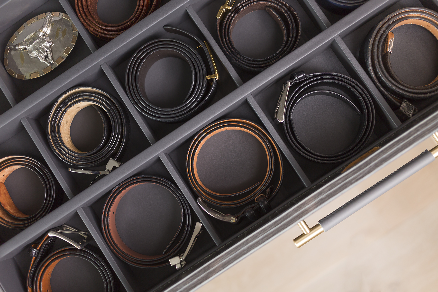A well organized drawer for belts.